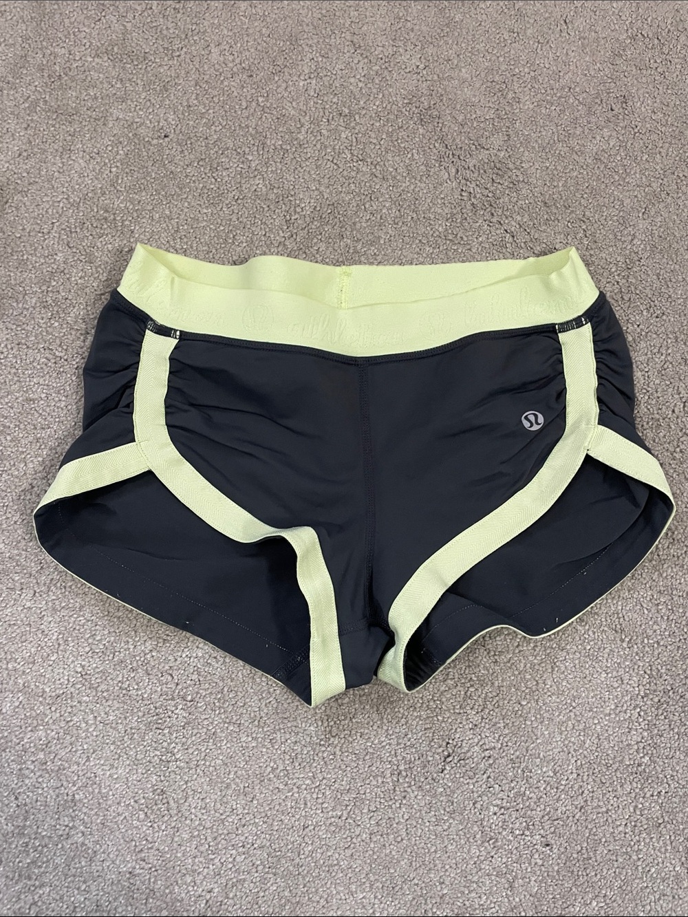 lululemon grey shorts with light green trim